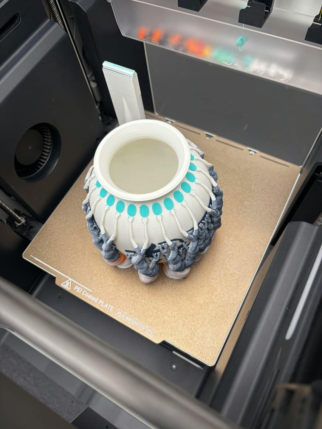 Multi-colored 3D printed object on a printer's heated build plate.